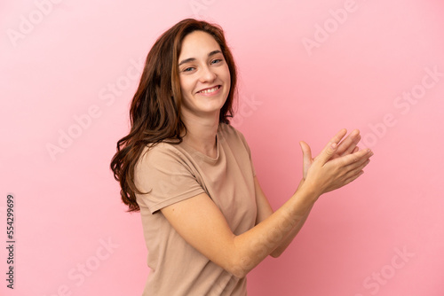Young caucasian woman isolated on pink background applauding © luismolinero