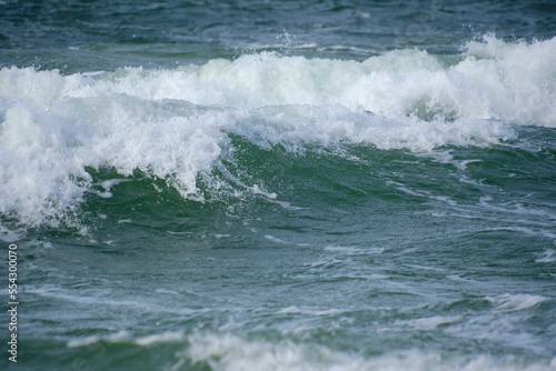 Surf wave with foam splashes on sea. © freeman83