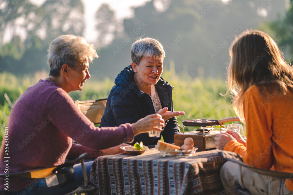 woman family having fun with food of picnic camp in the nature morning, summer travel vacation lifestyle of mother and girl at adventure forest park landscape in holiday, outdoors activity breakfast woman family having fun with food of picnic camp in the nature morning, summer travel vacation lifestyle of mother and girl at adventure forest park landscape in holiday, outdoors activity breakfast