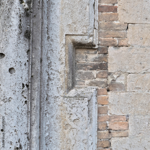 Italy, Perugia, summer 2022. Fragment of a wall with brick and stone inlays. Geometric ornamentation can be seen on the left © Siarhei