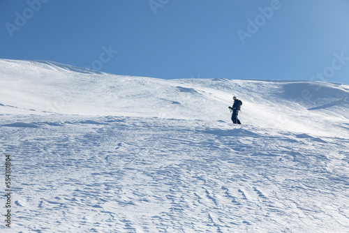 Epic scene of man at the summit of mountain as symbol of life success