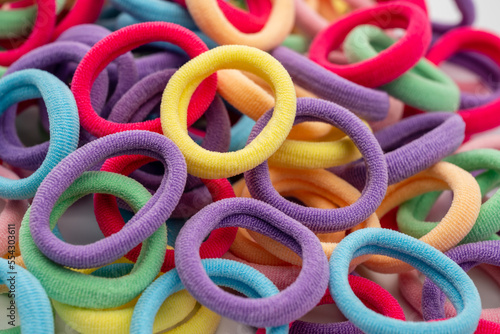 close up of a pile of brightly colored unisex elastic hair bands