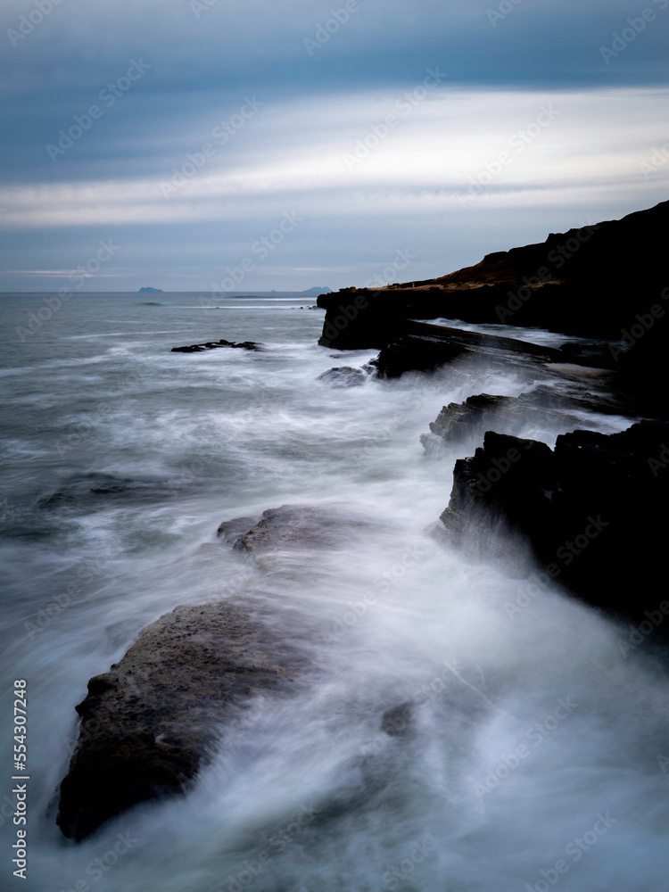 Fototapeta premium San Diego Seascape Series, dramatic cloudscape with stormy white seafoam splashing to the cliff at Sunset Cliffs in Cabrillo National Monument, Southern California, USA