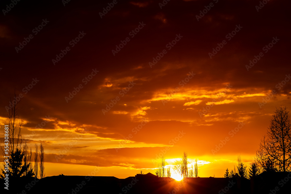 Dramatic colourful clouds glowing at sunset; Calgary, Alberta, Canada Dramatic colourful clouds glowing at sunset; Calgary, Alberta, Canada