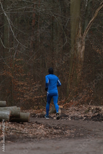A man is running in the woods