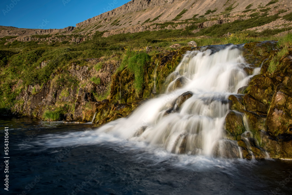 Vie of one of seven of the waterfalls at Dynjandi Waterfalls rushing down the cliffs on the Arnarfjörður in the Westfjords Region of Iceland; Arnarfjordur, Westfjords, Iceland Vie of one of seven of the waterfalls at Dynjandi Waterfalls rushing down the cliffs on the Arnarfjörður in the Westfjords Region of Iceland; Arnarfjordur, Westfjords, Iceland