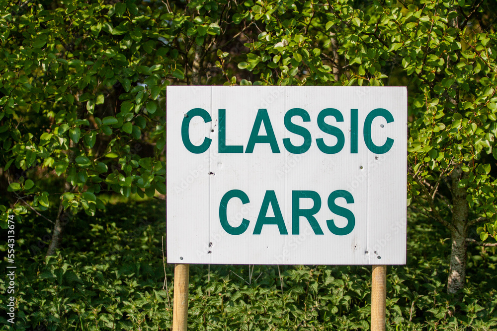 Classic Cars sign with hedging in the background