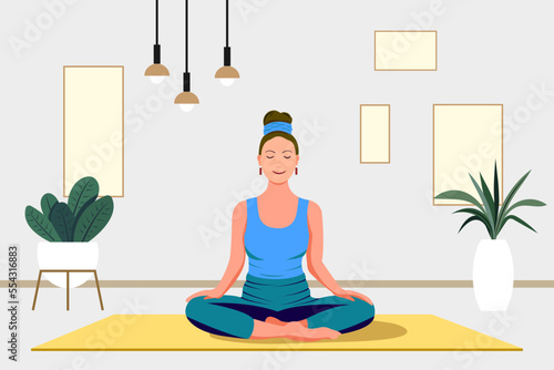 Yoga studio at home. woman sits in a meditation pose on a mat. Yoga classes at home. Interior of a modern apartment. Yoga concept.