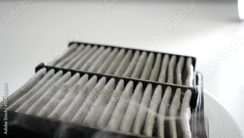 a old and dirty dusty car air filter rotation close-up photo