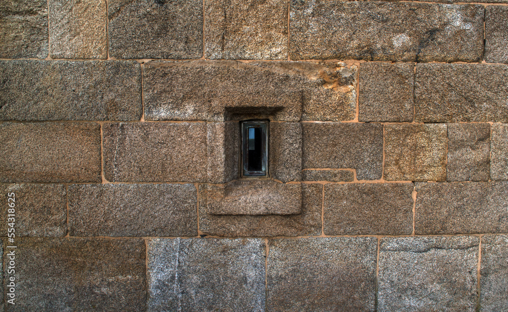 Window in the stone wall of the old fortress