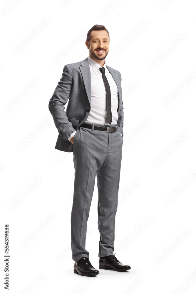 Full length shot of a smiling man in gray suit and tie Full length shot of a smiling man in gray suit and tie
