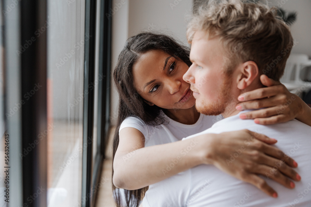 Affectionate lovely multiracial couple embracing with fondness Affectionate lovely multiracial couple embracing with fondness