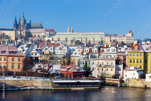 Sunny snowy Prague Lesser Town with gothic Castle from Charles Bridge  Czech republic