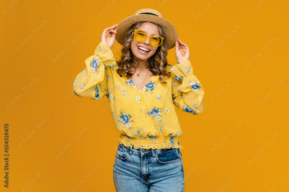 stylish happy smiling blond woman on vacation in straw on yellow background stylish happy smiling blond woman on vacation in straw on yellow background