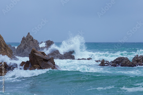 Strong storm in the Mediterranean Sea. The waves crash against the rocks producing large splashes.