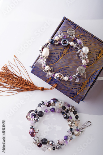 stylish jewelry semiprecious bracelets with present box around white background. hobby and fashion concept. photo