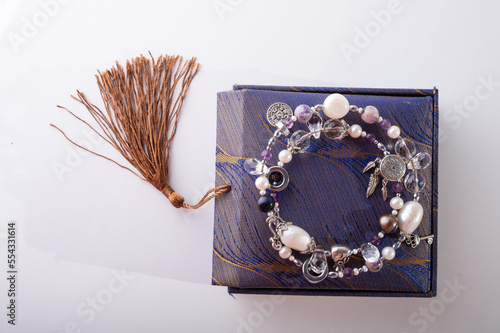 stylish jewelry semiprecious bracelet  with present box around white background. hobby and fashion concept. photo