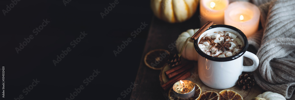 Autumn cozy home composition with hot chocolate with marshmallow and candles. Aromatherapy on a grey fall morning, atmosphere of cosiness and relax. Wooden background close up banner copy space Autumn cozy home composition with hot chocolate with marshmallow and candles. Aromatherapy on a grey fall morning, atmosphere of cosiness and relax. Wooden background close up banner copy space