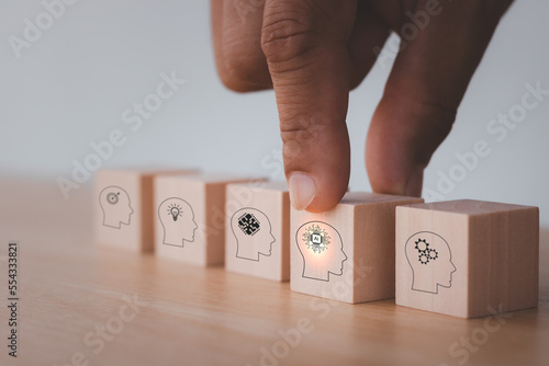 Digital skills concept. Hand holds wooden cube with 