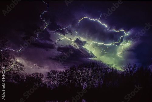 Lightning bolts illuminating a moody night sky; Nebraska, United States of America photo