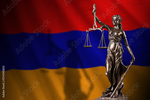 Armenia flag with statue of lady justice and judicial scales in dark room. Concept of judgement and punishment, background for jury topics photo