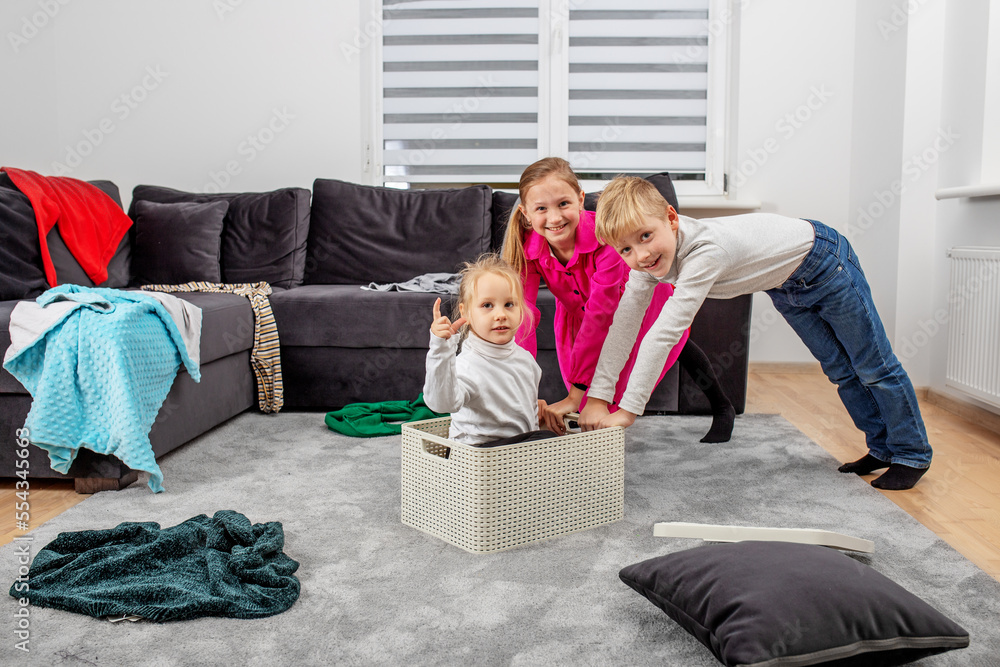 Obraz premium Three children are having fun in room and making mess. Happy childhood. Family concept.