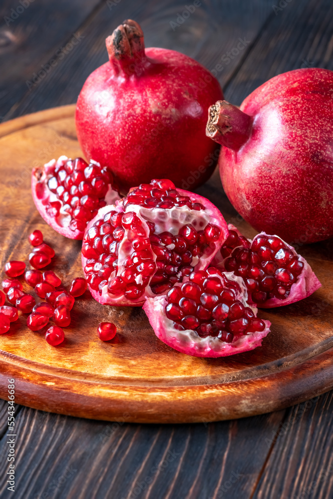 Fresh pomegranates on the wooden table Fresh pomegranates on the wooden table