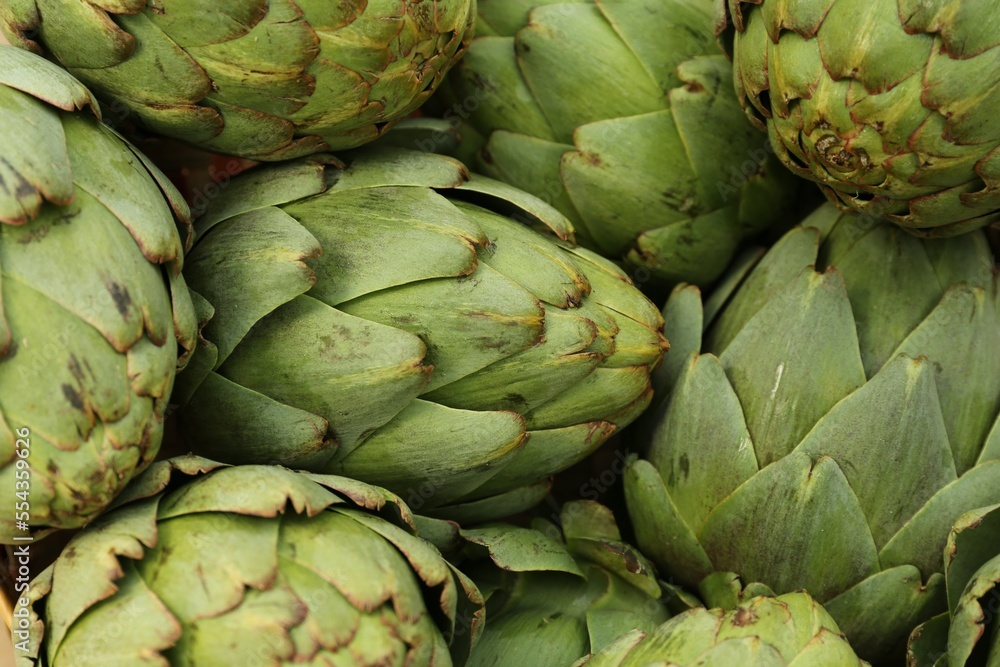 Many fresh raw artichokes as background, top view Many fresh raw artichokes as background, top view