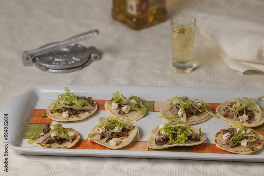 Chalupas, Typical Mexican dish made with tortillas, sauce, cheese, meat and lettuce.