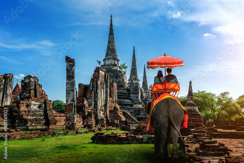 Couple on a ride elephant tour of the ancient city in ayutthaya, thailand.