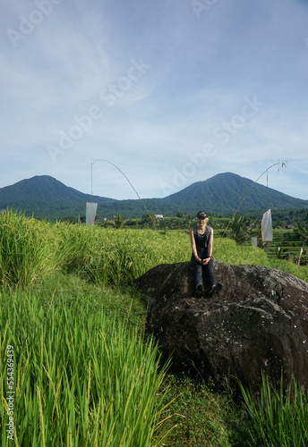 A woman walking around Tegalalang Rice field in Bali, Indonesia. photo