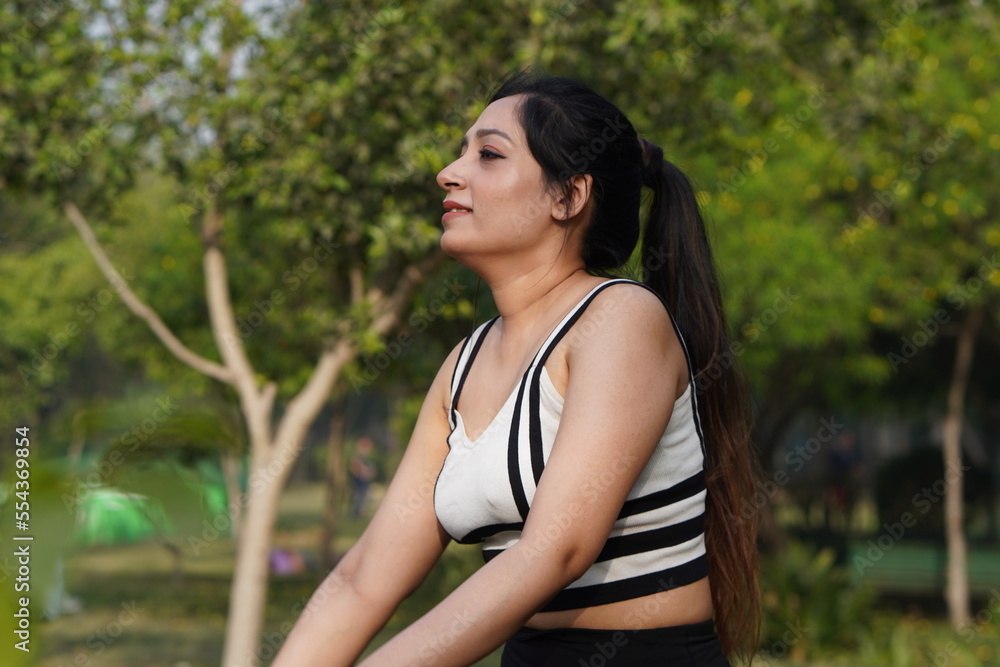 Running forward. Beautiful fitness woman runner runs in a park in the summer in a tracksuit. Running forward. Beautiful fitness woman runner runs in a park in the summer in a tracksuit.