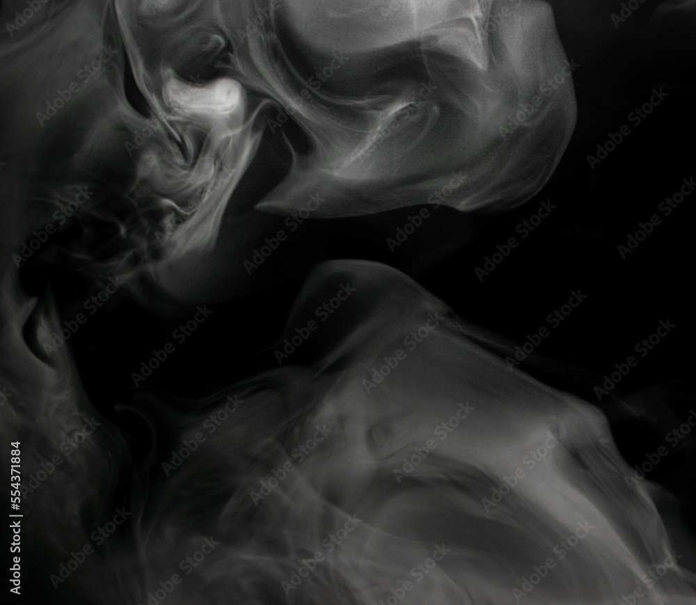White puffs of smoke on a black background float mixing in bizarre chaotic patterns of thin threads White puffs of smoke on a black background float mixing in bizarre chaotic patterns of thin threads