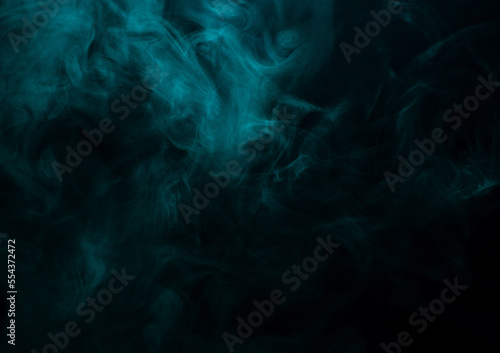 Abstract background of chaotically mixing clouds of turquoise smoke on a background of darkness