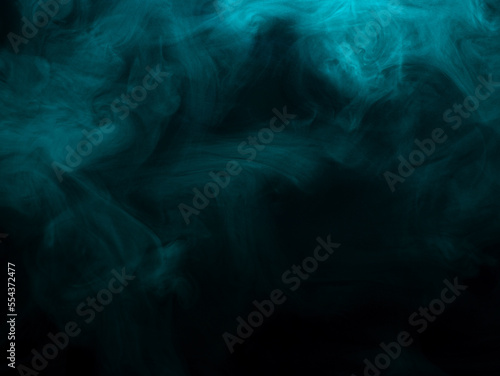 Abstract background of chaotically mixing clouds of turquoise smoke on a background of darkness