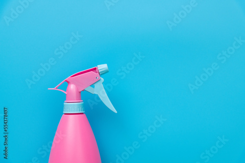 Plastic spray bottle on blue background