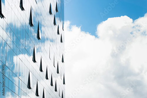 Clouds reflected in modern office building wall photo