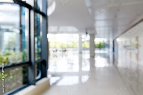 Fototapet Abstract defocused blurred background of empty long corridor in the modern hospi