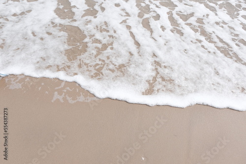 sea waves with sand on the beach natural for background.