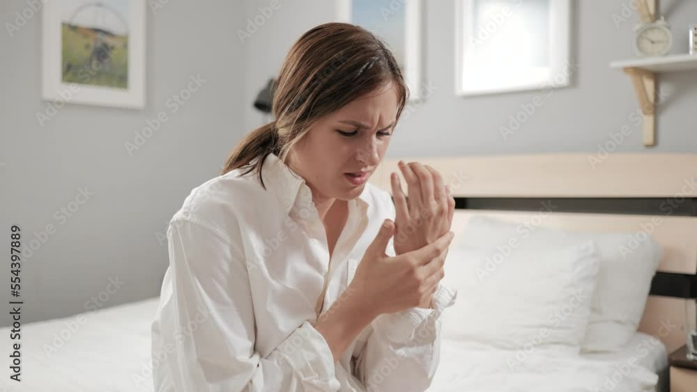 Wrist pain. Young woman suffering from pain in her hand trying to relieve pain in her wrist. Woman with carpal tunnel syndrome Wrist pain. Young woman suffering from pain in her hand trying to relieve pain in her wrist. Woman with carpal tunnel syndrome