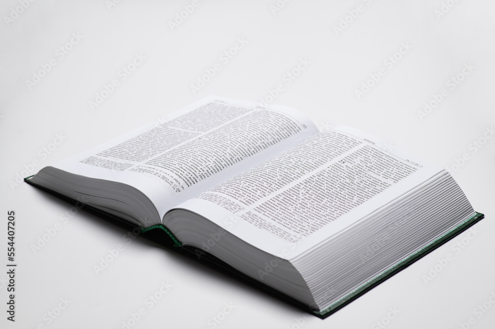 Fototapeta premium The book of the Bible in the Ukrainian language is open on a white background