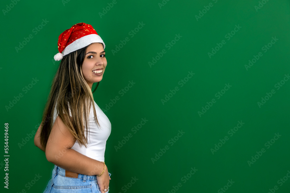 Woman in Santa hat for product demonstration Woman in Santa hat for product demonstration