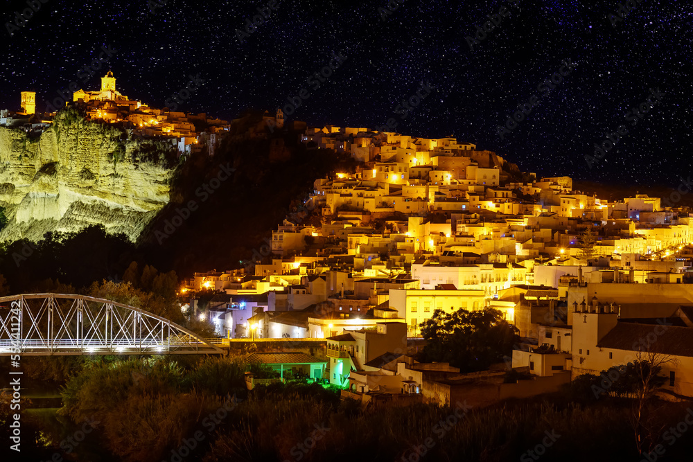 View of the picturesque town of Arcos de la Frontera at night with its white houses on the mountainside, Cadiz.