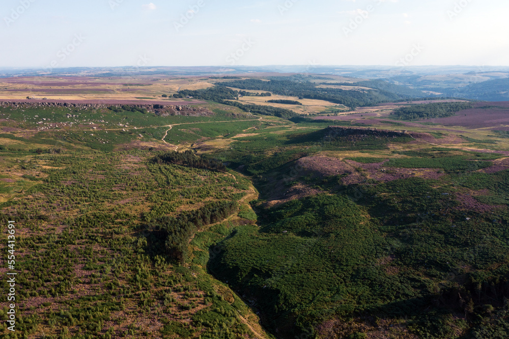 Stunning vibrant late Summer aerial drone landscape image of heather in full bloom in Peak District Stunning vibrant late Summer aerial drone landscape image of heather in full bloom in Peak District