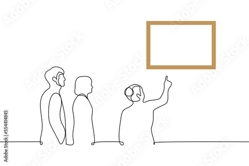 female tour guide pointing at a painting on the wall couple behind her listening - one line drawing vector. concept excursion for visitors in a museum or gallery photo
