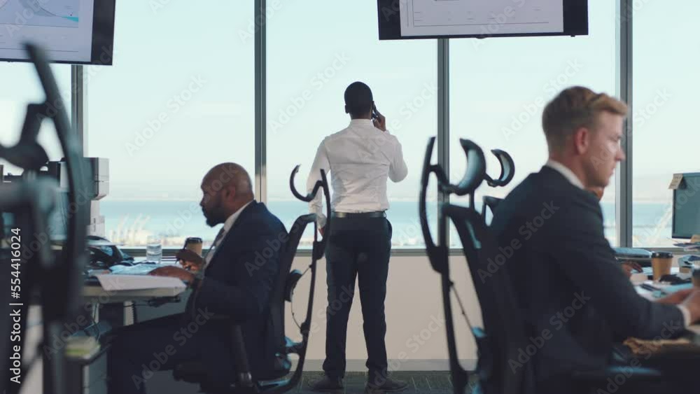 Busy, phone call and businessman walking in office with corporate staff, coworkers and colleagues. Communication, finance industry and business people sitting at desk working online for stock market Busy, phone call and businessman walking in office with corporate staff, coworkers and colleagues. Communication, finance industry and business people sitting at desk working online for stock market