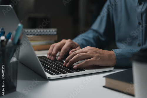 business man hands working and typing message on laptop keyboard on table.concept for technology device contact communication.