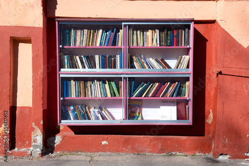 Outdoor bookcase for free book exchange on a sunny day