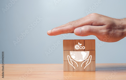 Long-term, climate-neutral strategy Hands laying wooden cubes with carbon emission reduction and green icon. Low carbon, carbon neutral concept. green banne
