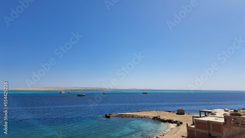 Beach and sea. Blue sky and white clouds. Boats. Red sea. Egypt. Hurghada